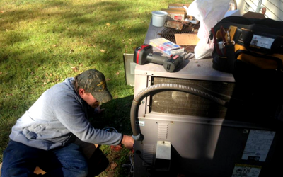 guy working on the hose to a central unit 